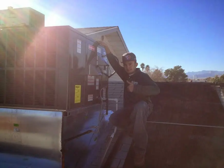 HVAC technician performing HVAC Inspection on a rooftop unit in Delavan